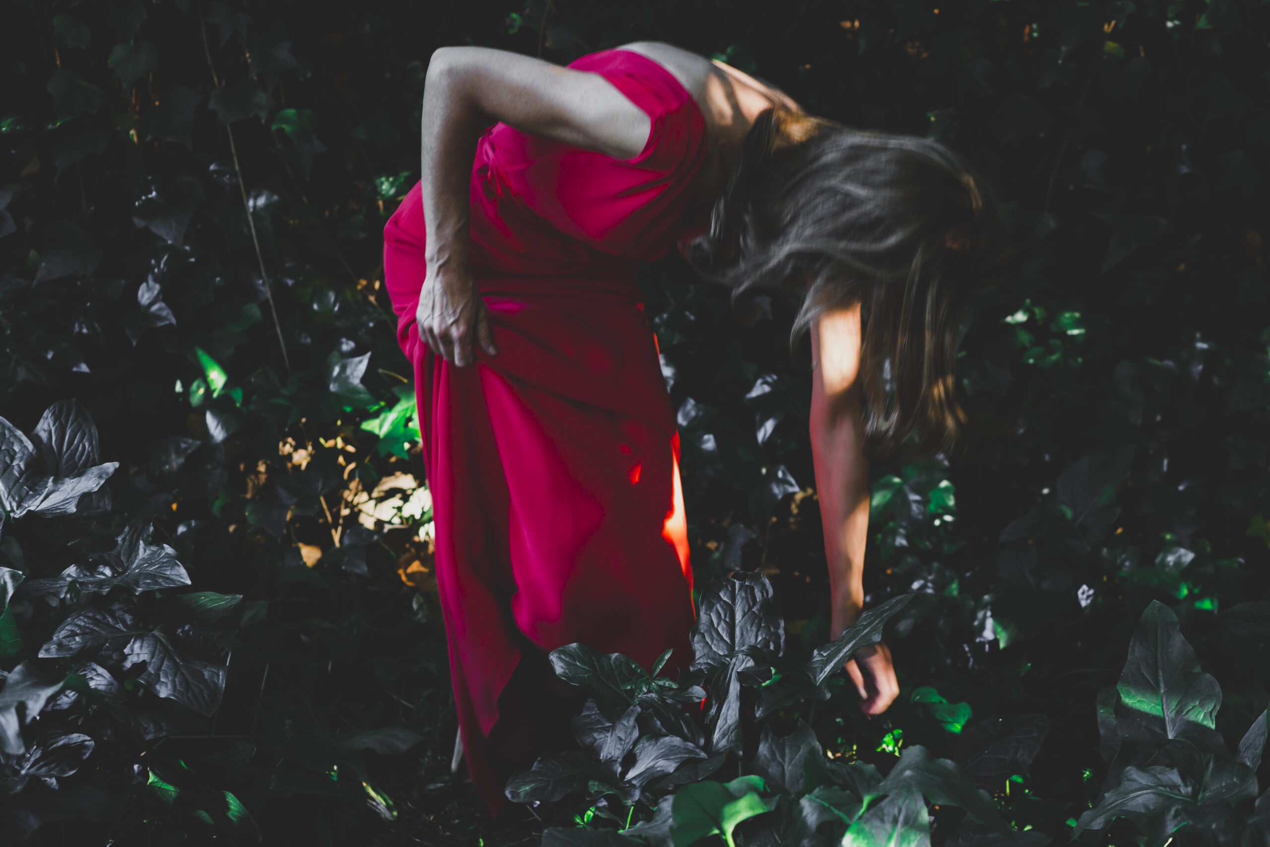 side-view-woman-touching-grass-garden